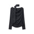 Black long-sleeve top with asymmetrical draped neckline and fabric scarf detail