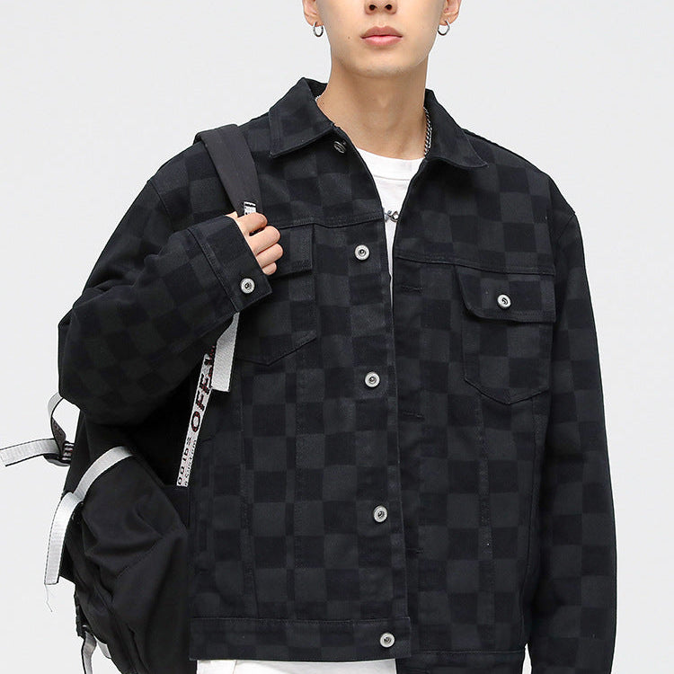 A model is wearing a black checkered jacket with backpack, posing against white background in white tee and tan cargo pants
