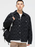 A model is wearing a black checkered jacket with backpack, posing against white background in white tee and tan cargo pants