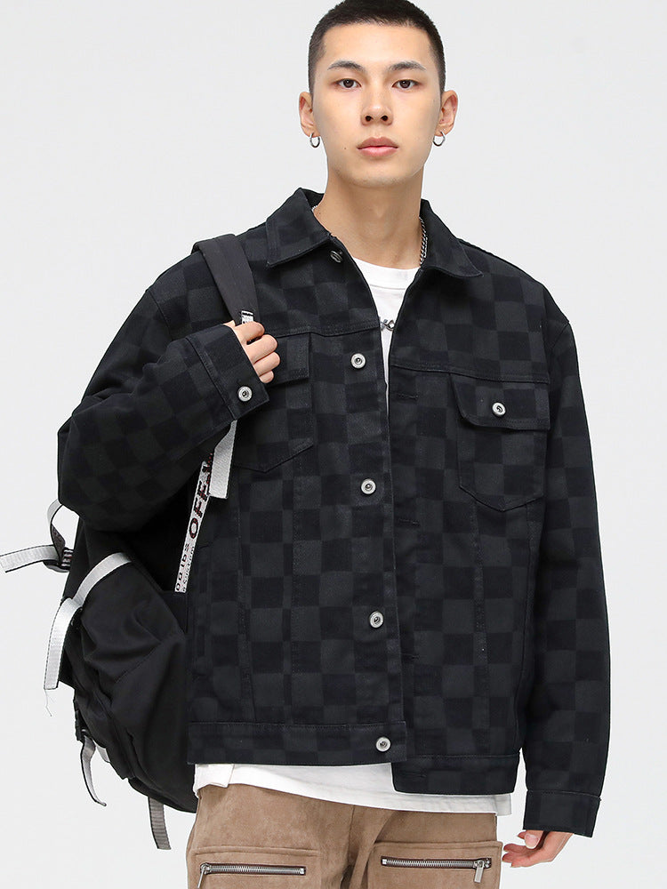 A model is wearing a black checkered jacket with backpack, posing against white background in white tee and tan cargo pants