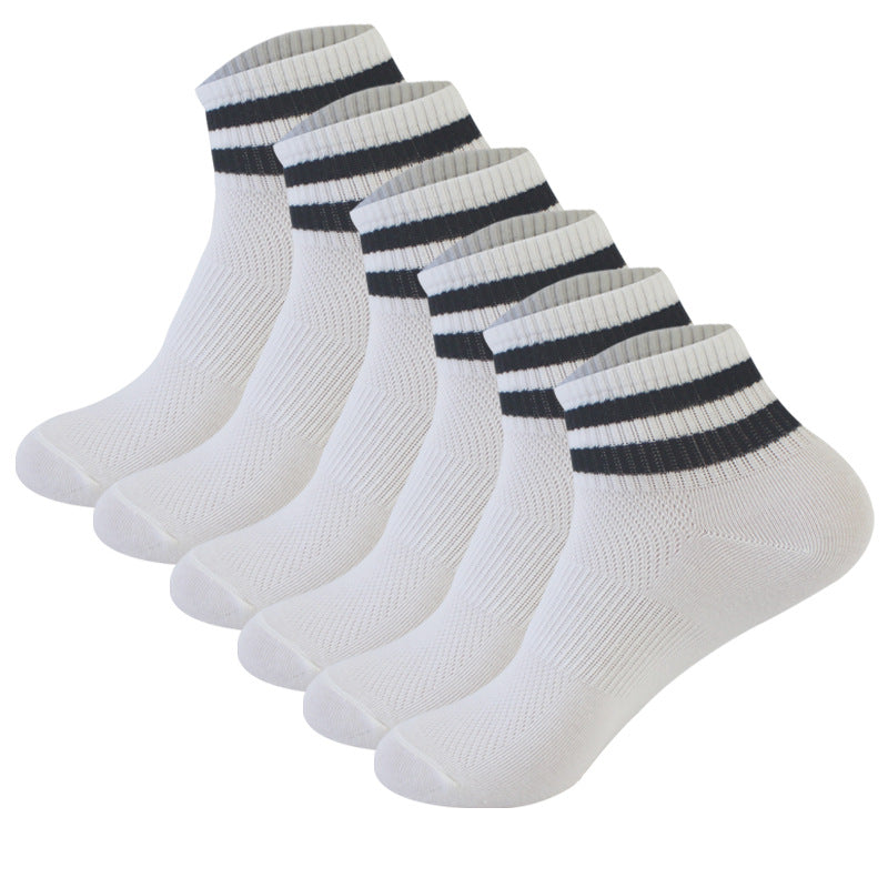 Six-pack of white athletic ankle socks with black striped cuffs, arranged in a row showing ribbed knit texture