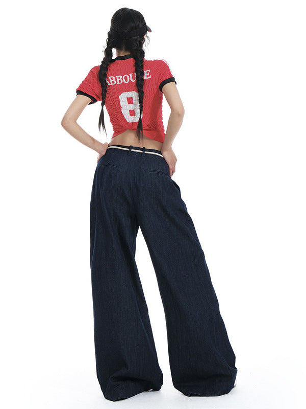 Back view of dark denim wide-leg jeans worn with a red graphic crop top.