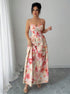 Woman wearing a floral dress in a minimalistic setting