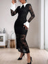 A woman wearing a gothic-inspired black lace dress with sheer detailing, a white pointed collar, and white statement cuffs.