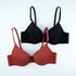 Multiple black and rust-colored bras displayed against white background