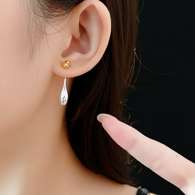 Two-tone gold and silver Water Drop dangle earrings on ear