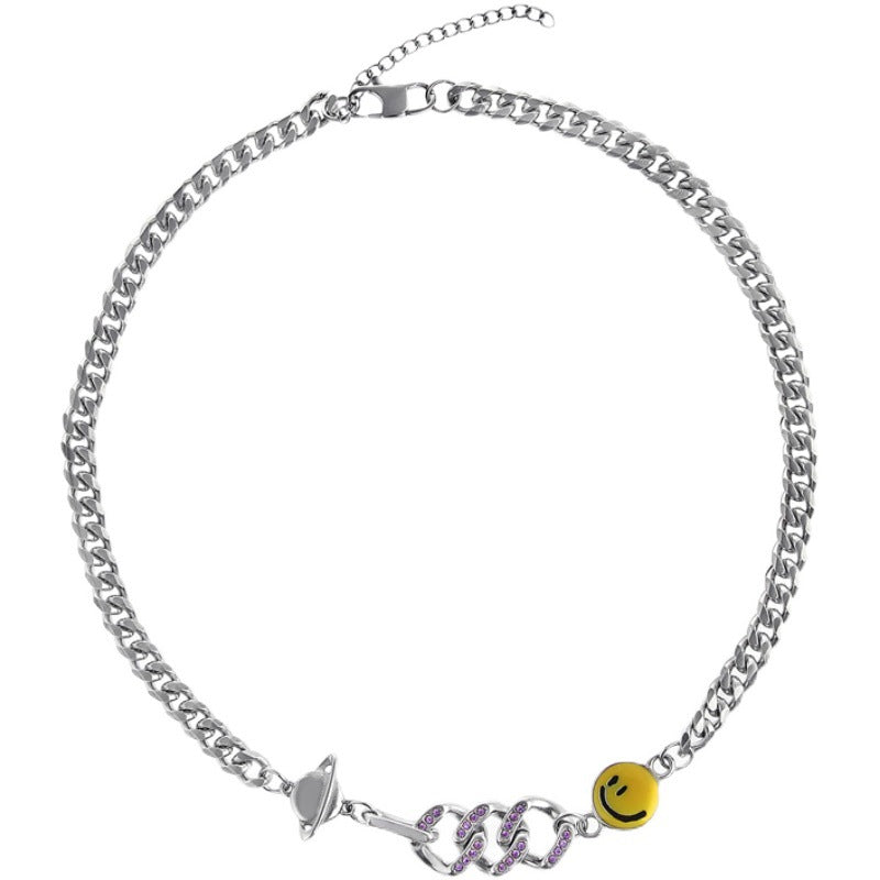 Titanium Steel Cuban chain necklace laid flat showing full length, featuring yellow smiley charm, silver planet charm, and purple crystal-encrusted snake design with adjustable extender