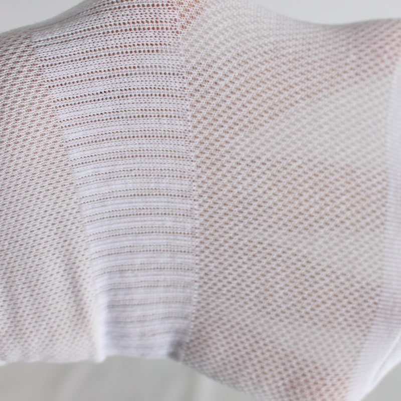 Close-up texture detail of white sock's breathable mesh knit pattern