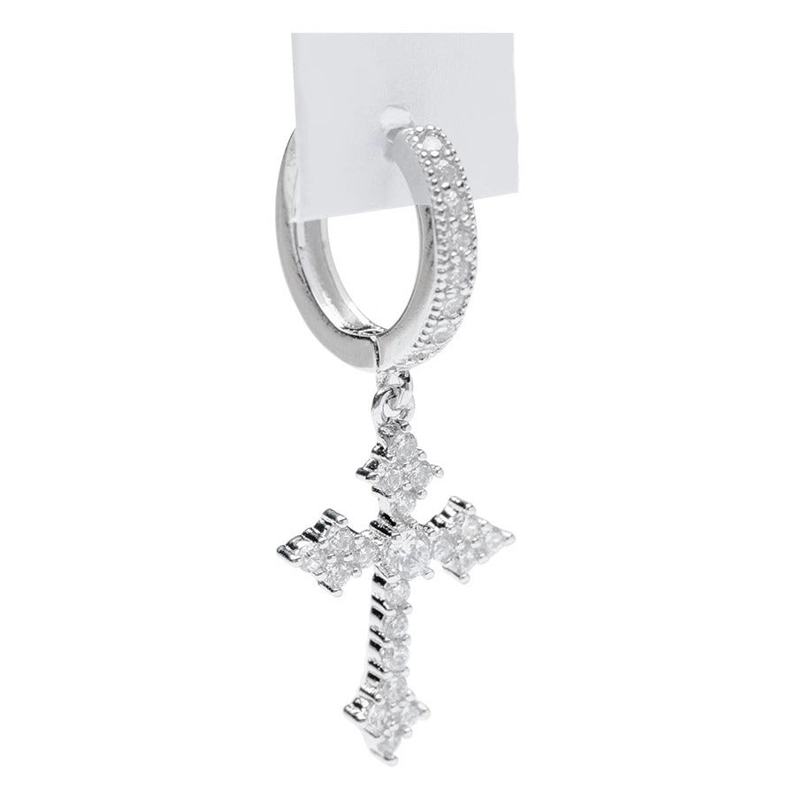 Close-up side view of single zircon cross drop earring with white product tag