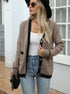 Black cardigan with beige trim, worn with white tank top and jeans, woman wearing sunglasses and hat