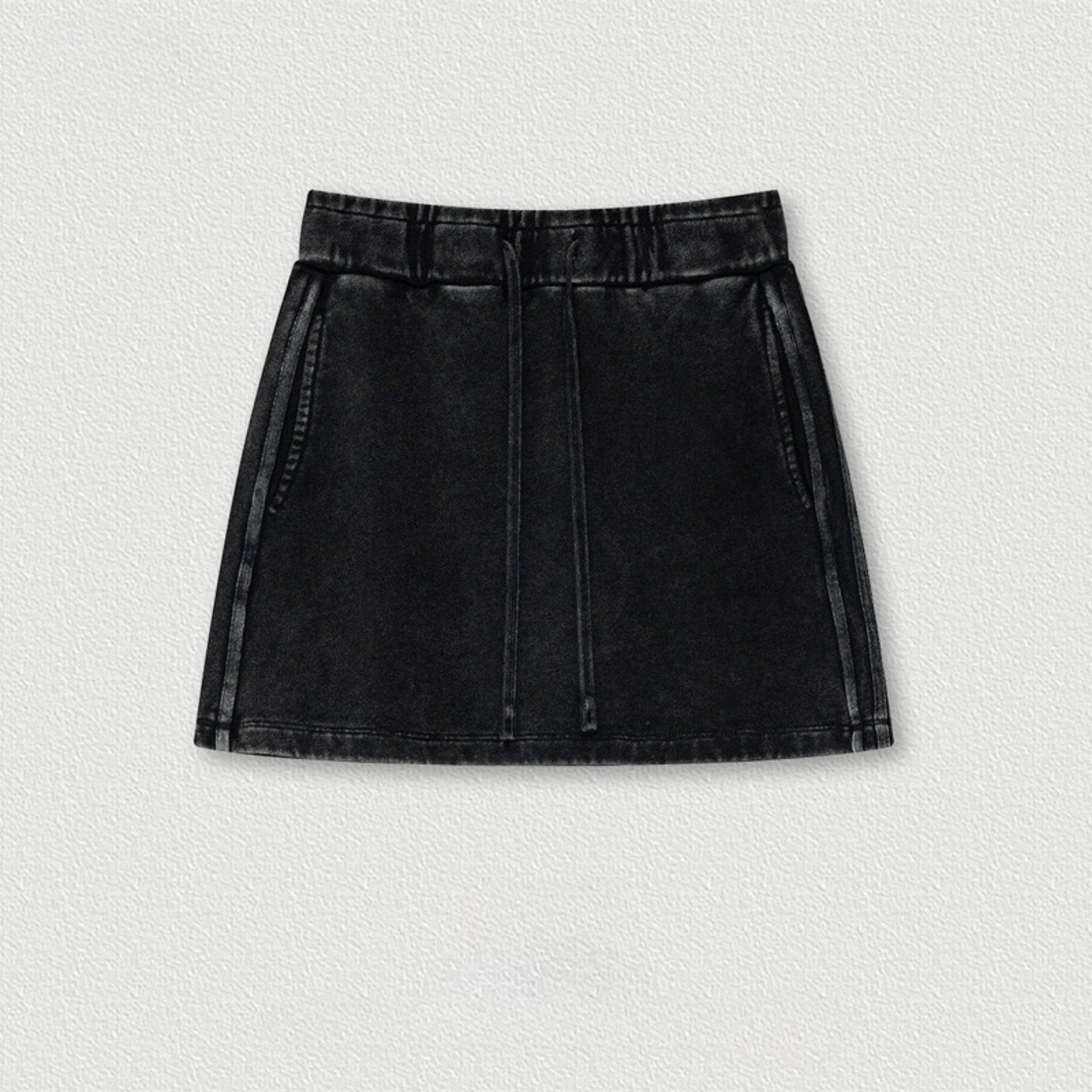 Black denim mini skirt with elastic waistband and drawstring, shown flat against white background