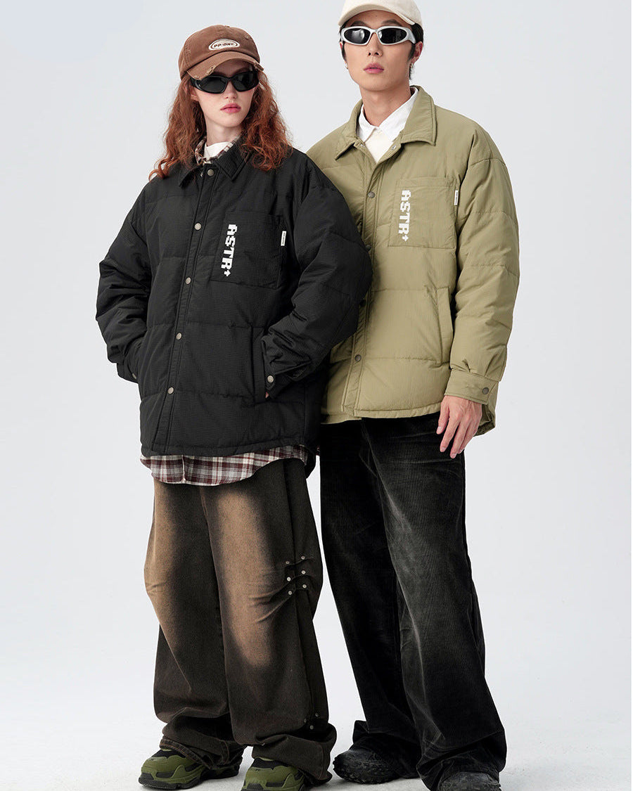 Models standing side by side in ASTROSMASH puffer jackets - black and olive versions with white logos and sunglasses