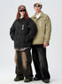 Models standing side by side in ASTROSMASH puffer jackets - black and olive versions with white logos and sunglasses