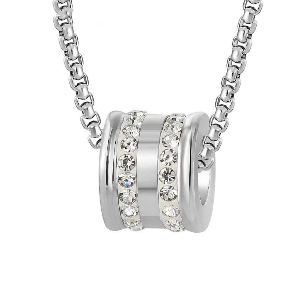 Silver chain necklace with cylindrical pendant featuring crystal bands