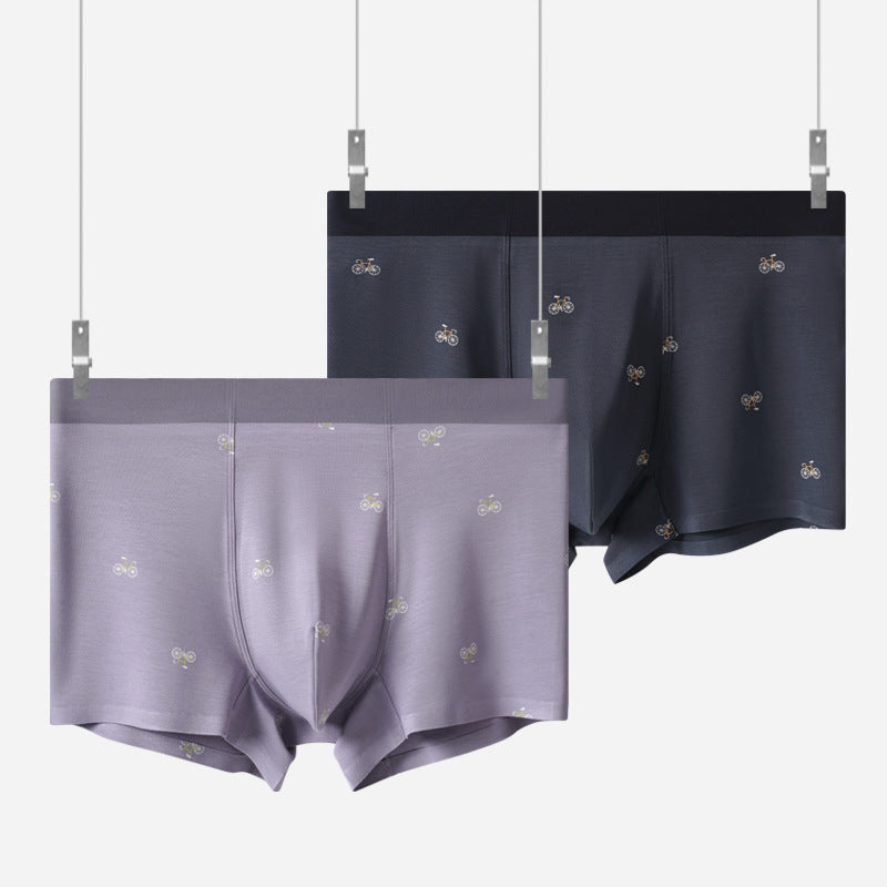 Navy and lavender men's boxer briefs with bicycle print displayed hanging, product showcase