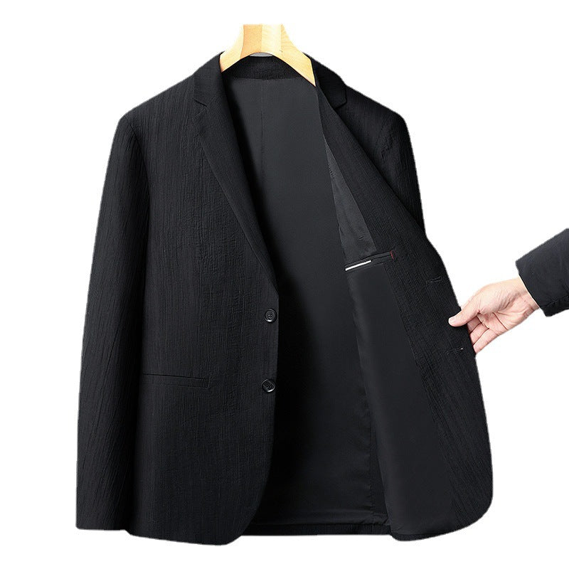 Black textured blazer displayed on wooden hanger with partially opened front showing inner lining and hand pointing to interior pocket