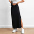 Black long skirt with V-shaped twisted waistband and side slit, paired with white sneakers and a hint of a white top