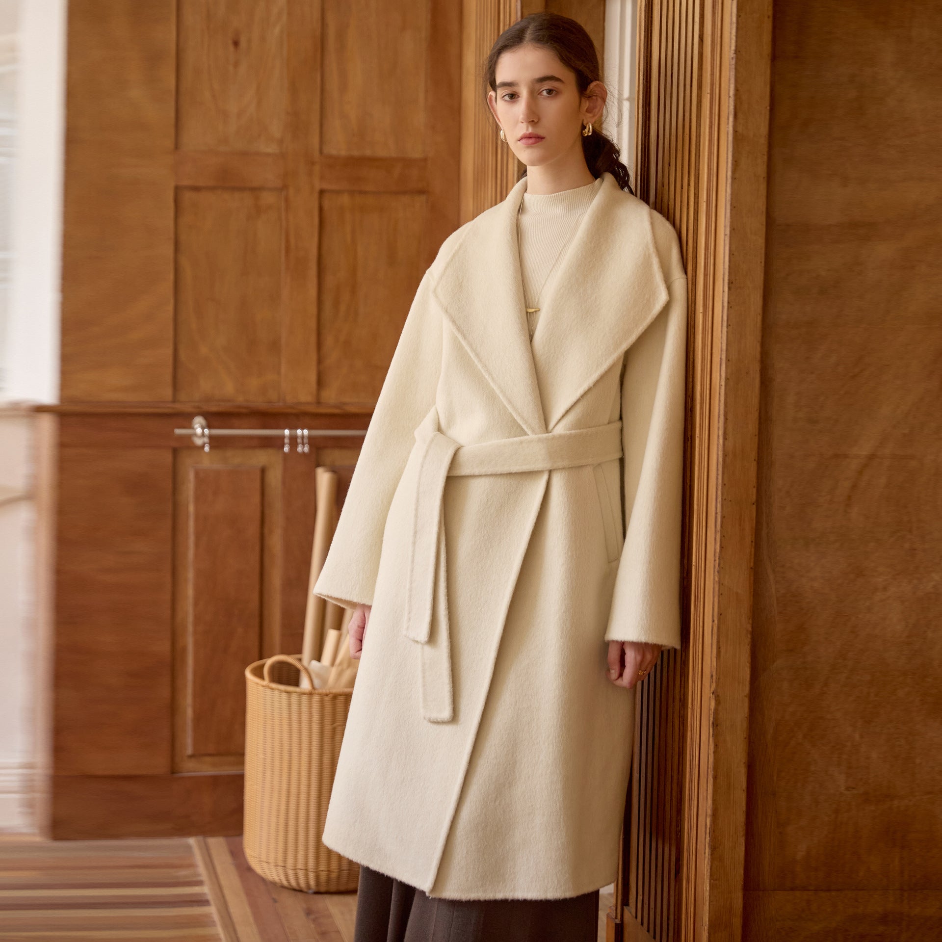 Full front view of cream wrap coat with oversized lapels on model