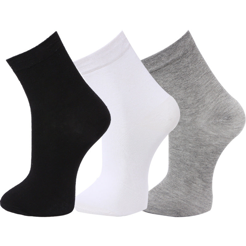Set of three ankle socks in black, white, and gray displayed against a white background