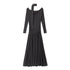 Full product shot of black jersey maxi dress with off-shoulder neckline, attached scarf, ruched waist, and floor-length gathered skirt