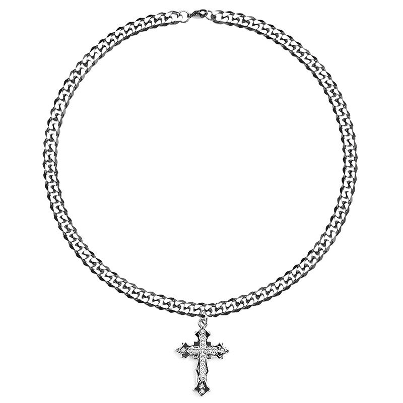 Silver Cuban link necklace with a cross pendant displayed against a white background