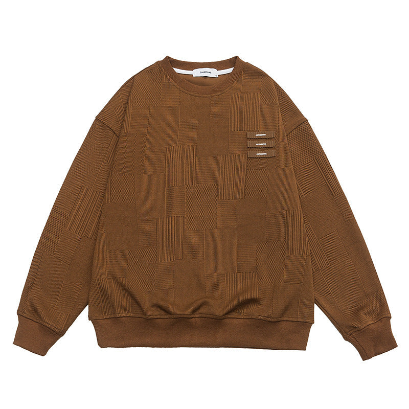 Product shot of brown textured sweatshirt with three decorative tabs on white background
