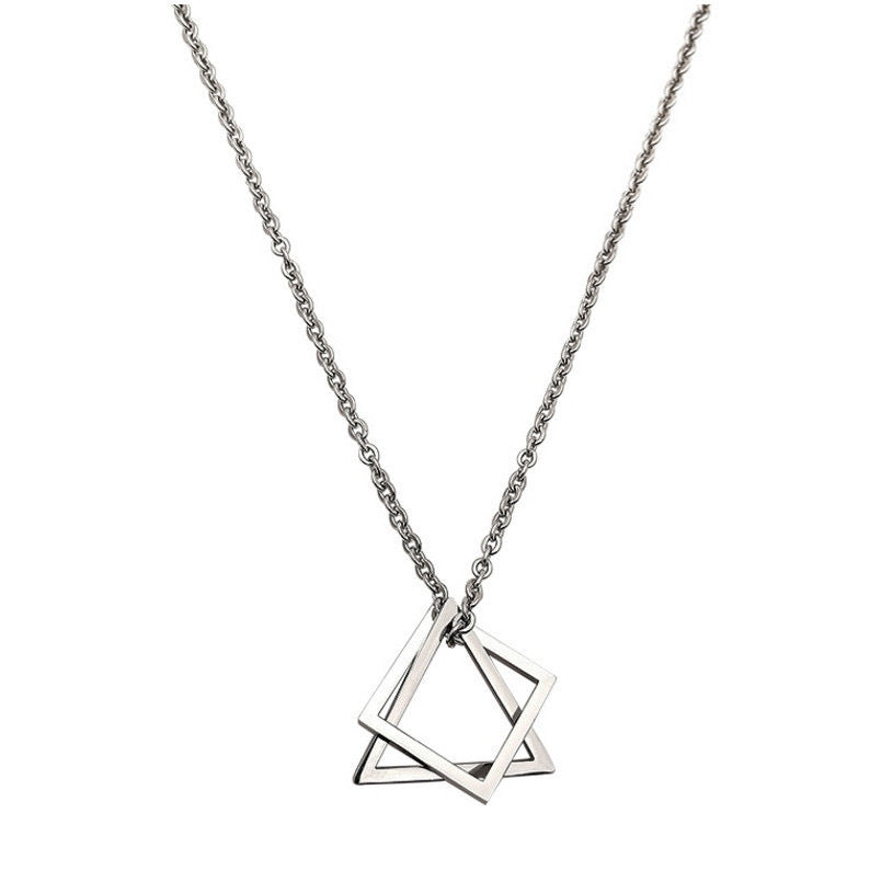 Close-up of a silver geometric pendant necklace with a chain, featuring a modern square and triangle charm design