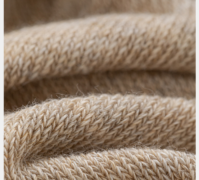 Detailed texture view of cream knit leg warmer fabric