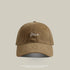 Brown baseball cap with 'Me' embroidered in white cursive, vintage washed cotton, and a curved brim