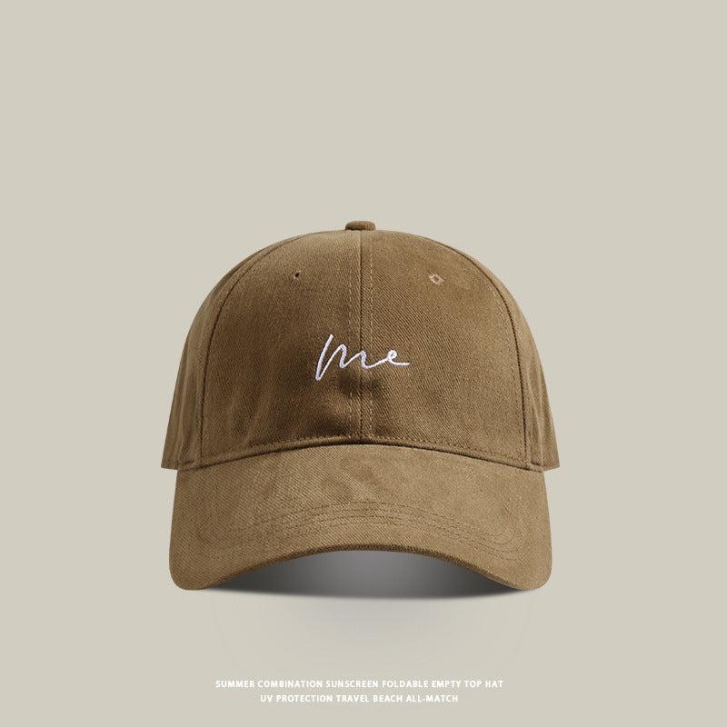 Brown baseball cap with 'Me' embroidered in white cursive, vintage washed cotton, and a curved brim