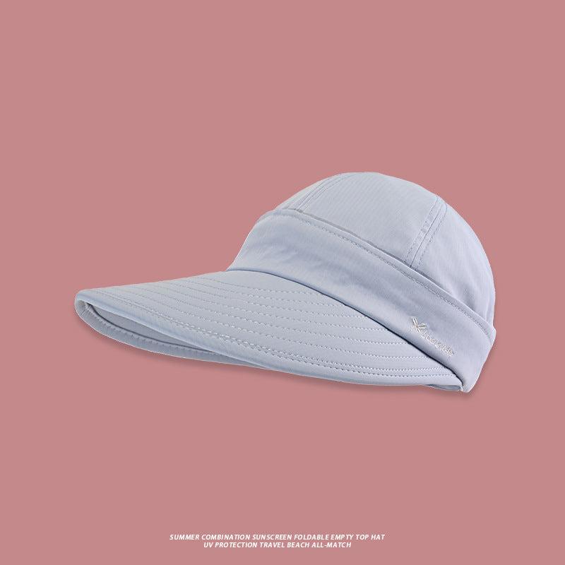 A light blue UV protection sun visor with wide brim and white logo detail presented against dusky pink backdrop