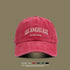 Red washed cotton baseball cap with white 'LOS ANGELES VINTAGE MADE' embroidery on front against neutral background