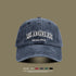 Navy blue washed cotton baseball cap with white embroidered Los Angeles text and color selection options below