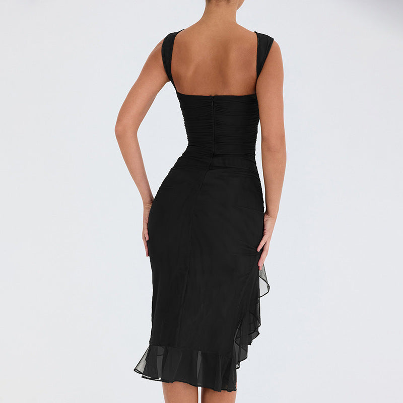 A model is wearing a black ruched bodycon dress with flared asymmetrical hem, posing with back view against white backdrop