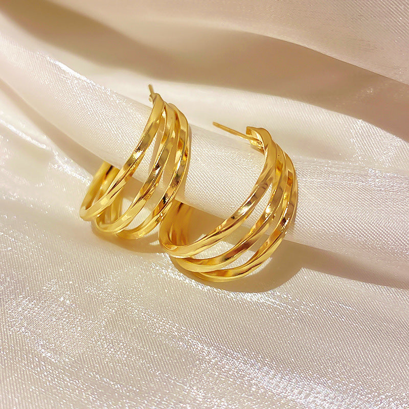 Twisted gold knot stud earrings with matte finish