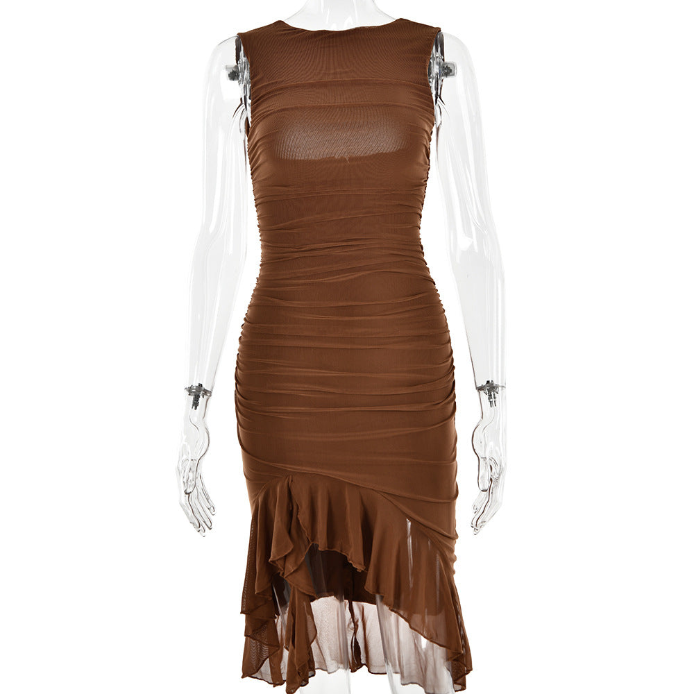 A model is wearing a brown sleeveless bodycon dress with ruched detailing and asymmetrical ruffled hem against white backdrop