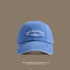 A blue washed denim baseball cap with white 'San Francisco USA California' embroidery displayed against taupe background with UV protection text