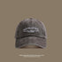 A charcoal gray washed cotton baseball cap with white 'San Francisco USA California' embroidery shown against taupe background with sun protection text