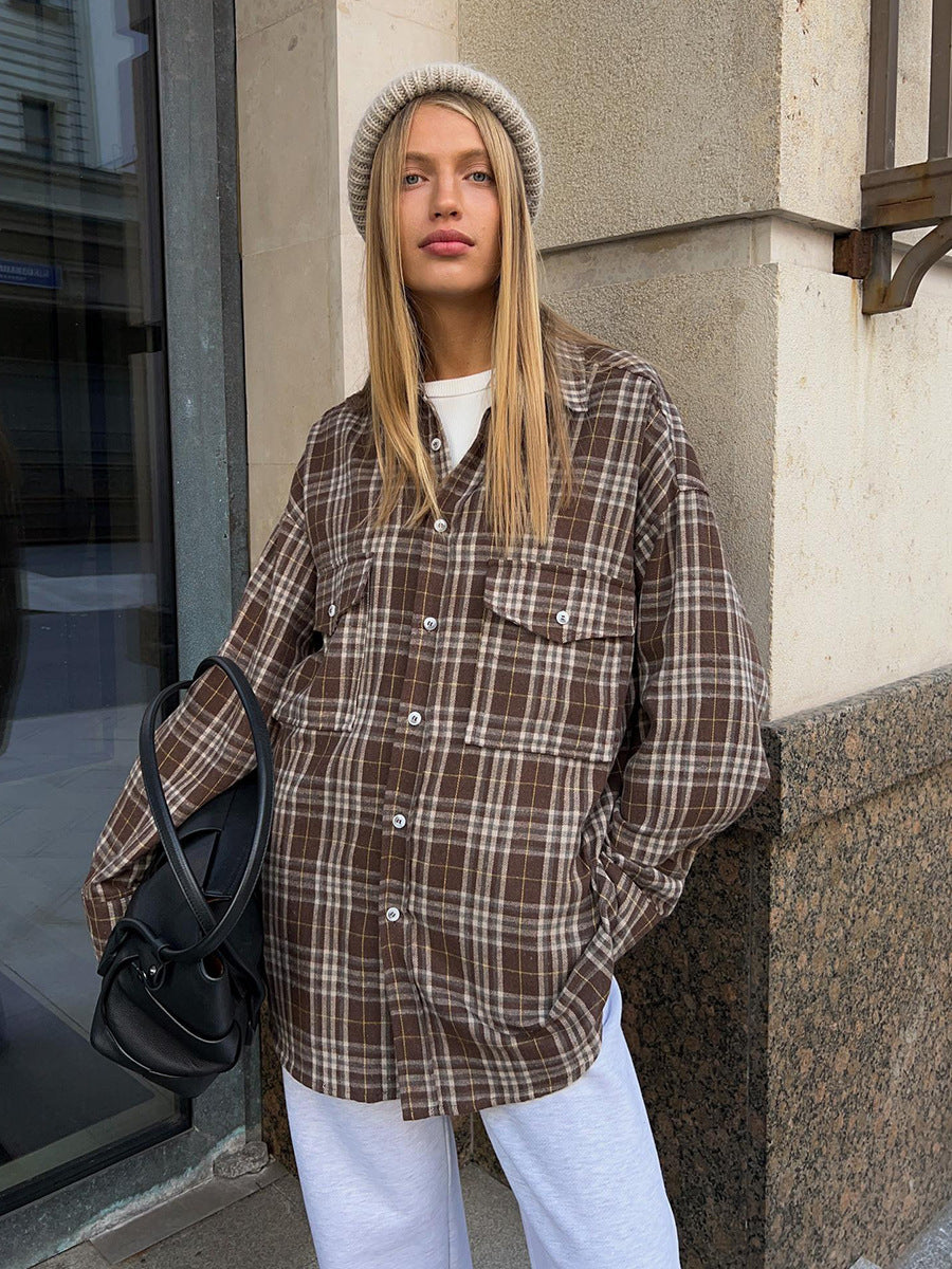 Oversized brown plaid flannel shirt with chest pockets styled with white joggers and gray knit beanie, casual winter streetwear look