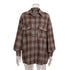Brown plaid flannel shirt on mannequin display showing oversized fit and chest pocket details
