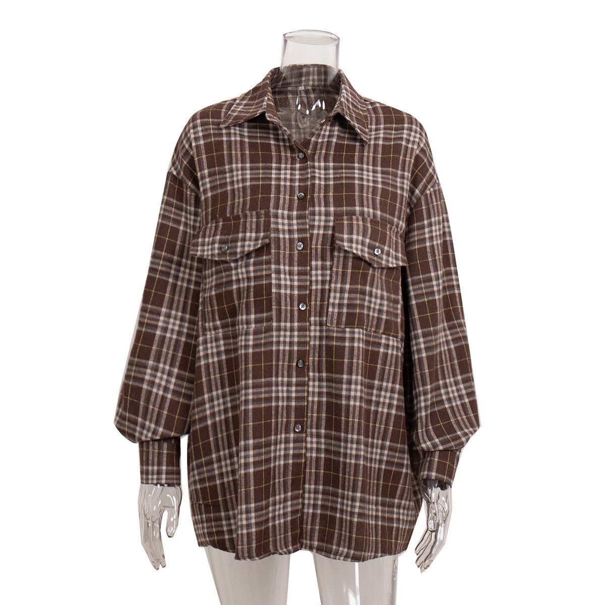 Brown plaid flannel shirt on mannequin display showing oversized fit and chest pocket details