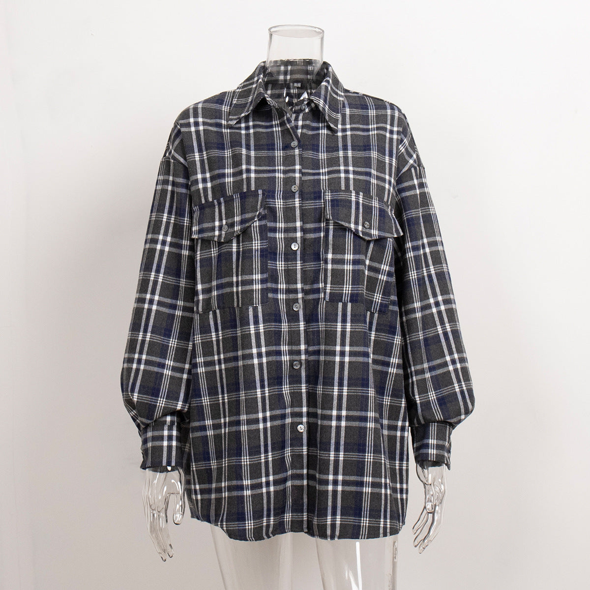 Navy blue plaid flannel shirt on mannequin, featuring oversized silhouette and button-front design