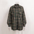 Forest green plaid oversized shirt on mannequin, showcasing windowpane pattern and relaxed fit