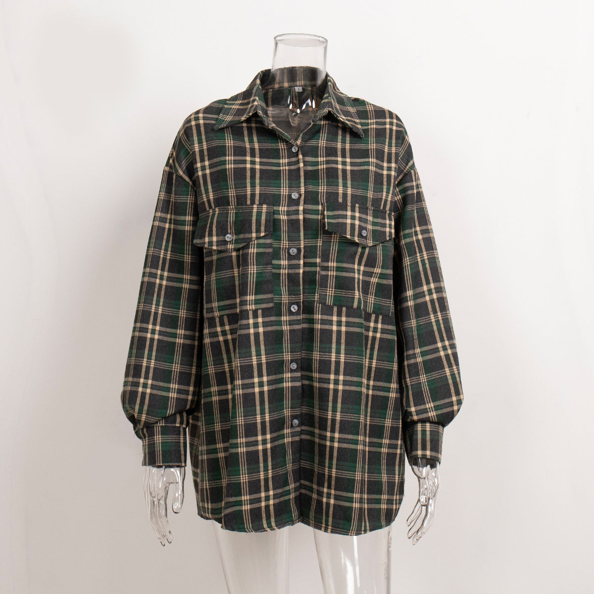 Forest green plaid oversized shirt on mannequin, showcasing windowpane pattern and relaxed fit