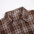 Detail shot of shirt collar and button placket in brown plaid pattern with size label