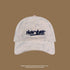 White corduroy baseball cap with navy 'NEW YORK' embroidery on front