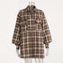 A brown plaid oversized button-up flannel shirt with two front pockets displayed on a clear mannequin