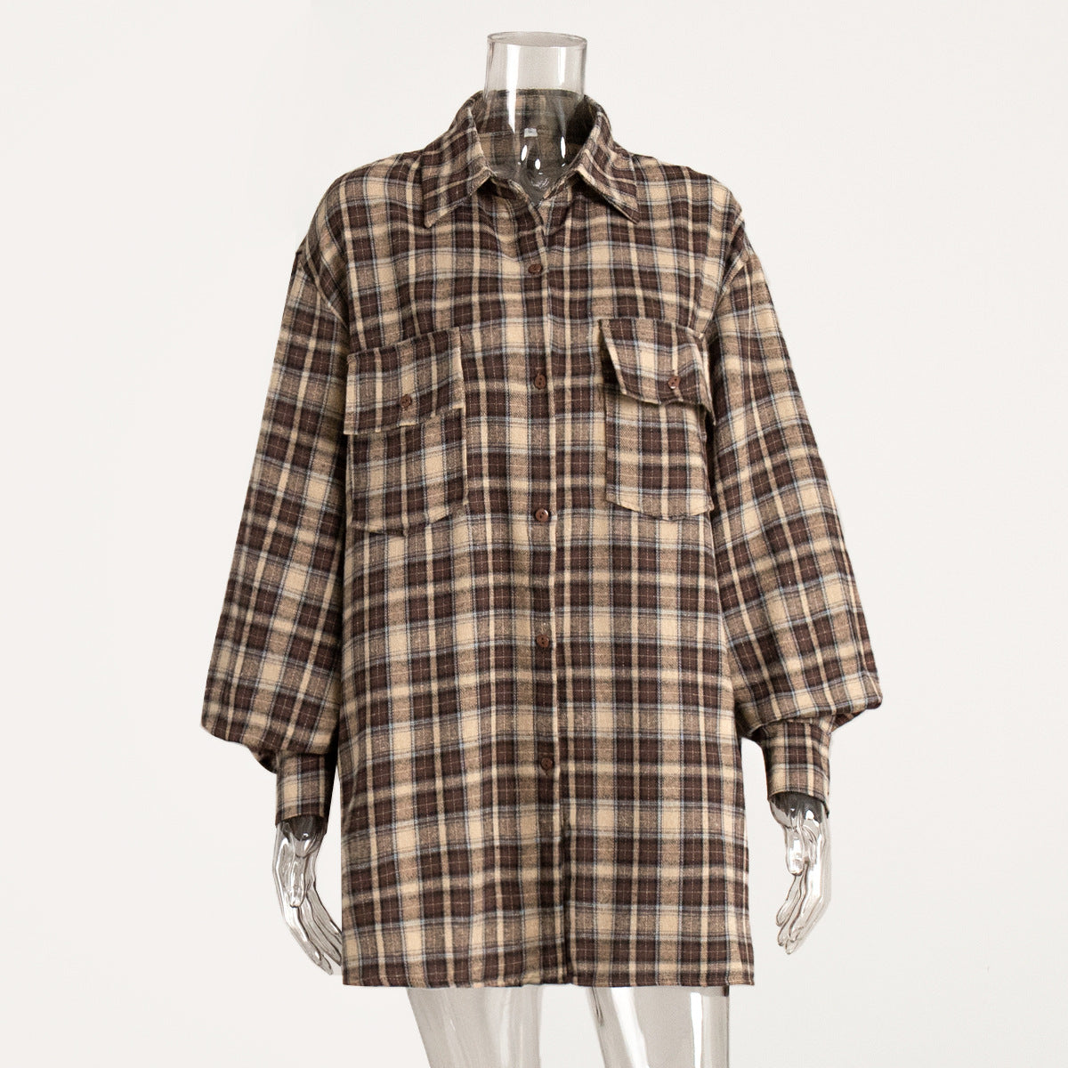 A brown plaid oversized button-up flannel shirt with two front pockets displayed on a clear mannequin
