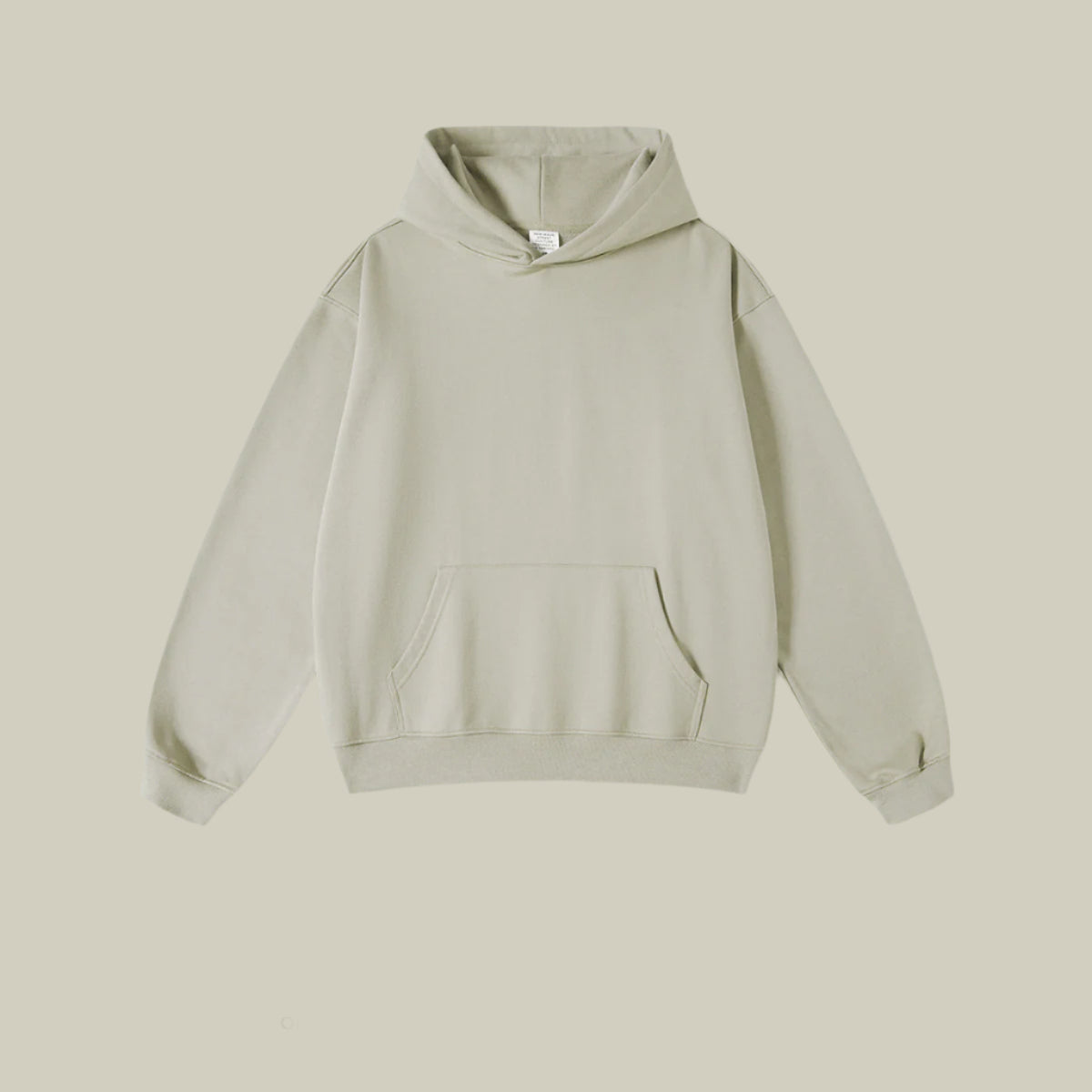 Light sage green hoodie with front pocket on light neutral background