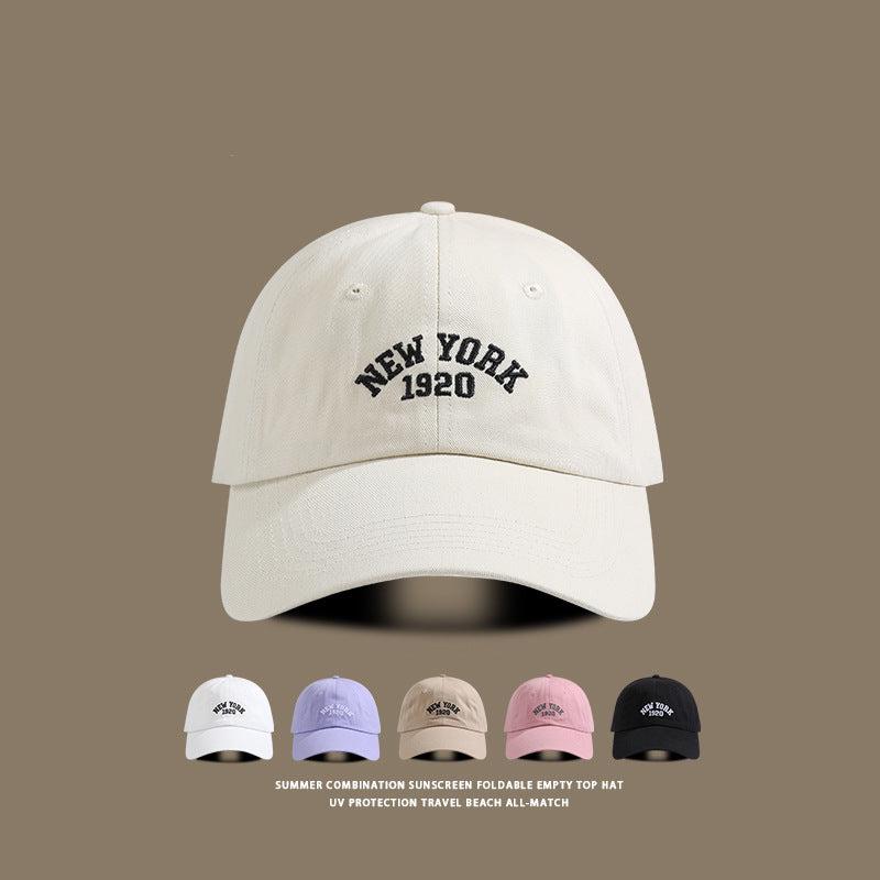 Beige baseball cap with "New York 1920" embroidery, displayed alongside other available colors: purple, khaki, pink, and black